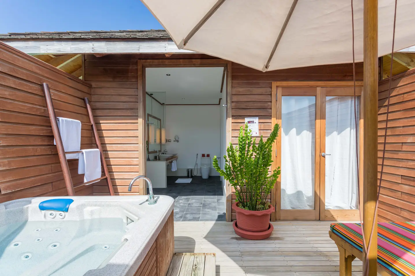meeru maldives jacuzzi water villa jacuzzi area with serene lagoon views soft natural light and a calm refined setting that reflects the resort’s relaxed luxury atmosphere