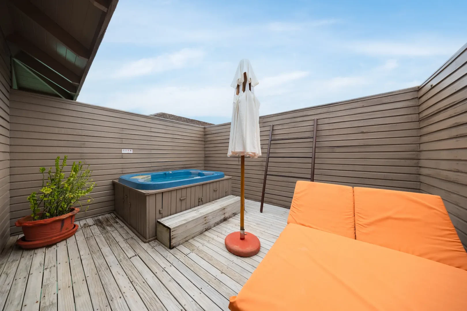meeru maldives jacuzzi water villa sunbeds overlooking the calm turquoise lagoon with soft natural light and a serene private deck that reflects the resort’s relaxed luxury atmosphere