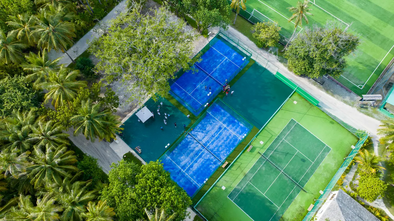 meeru maldives padel tennis and tennis courts with bright natural light smooth court surfaces and a relaxed outdoor setting designed for an active luxury resort experience