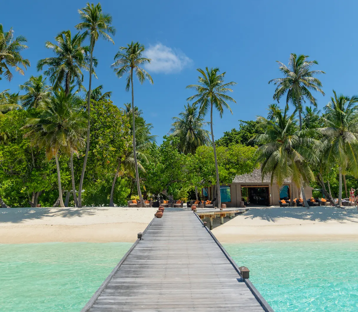 meeru maldives pavilion bar with soft ambient lighting relaxed open air seating and a calm tropical atmosphere reflecting the resort’s refined luxury style