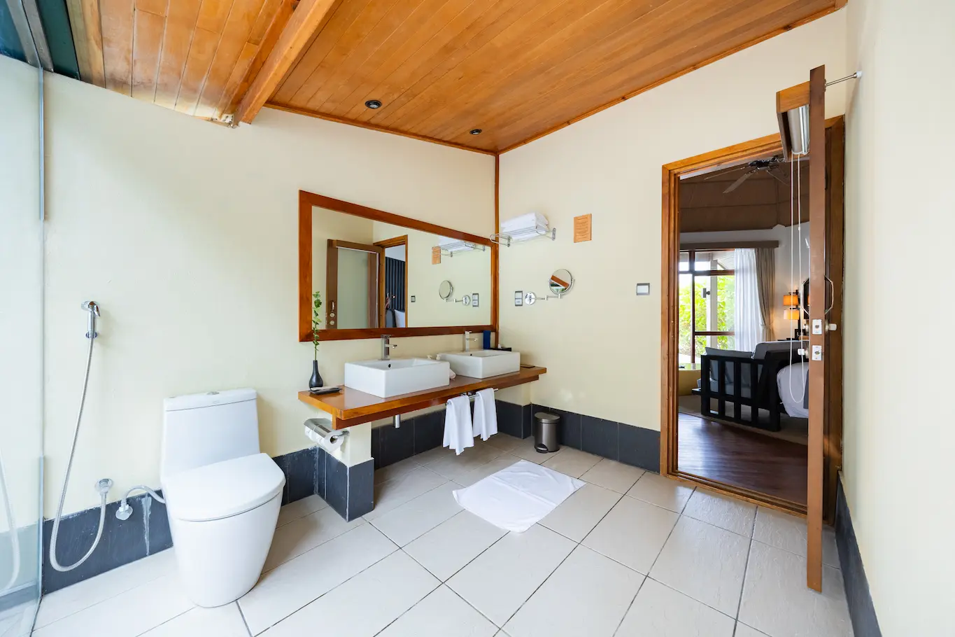 meeru maldives waterfront villa bathroom featuring soft natural lighting elegant stone details and a calm refined layout that enhances the resort’s relaxed luxury atmosphere