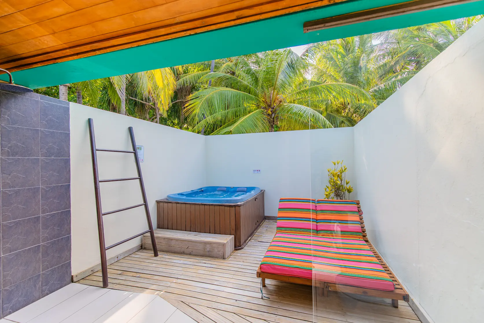 meeru maldives waterfront villa sun loungers facing the calm turquoise lagoon with soft natural light and a serene private beachfront atmosphere reflecting the resort’s relaxed luxury style
