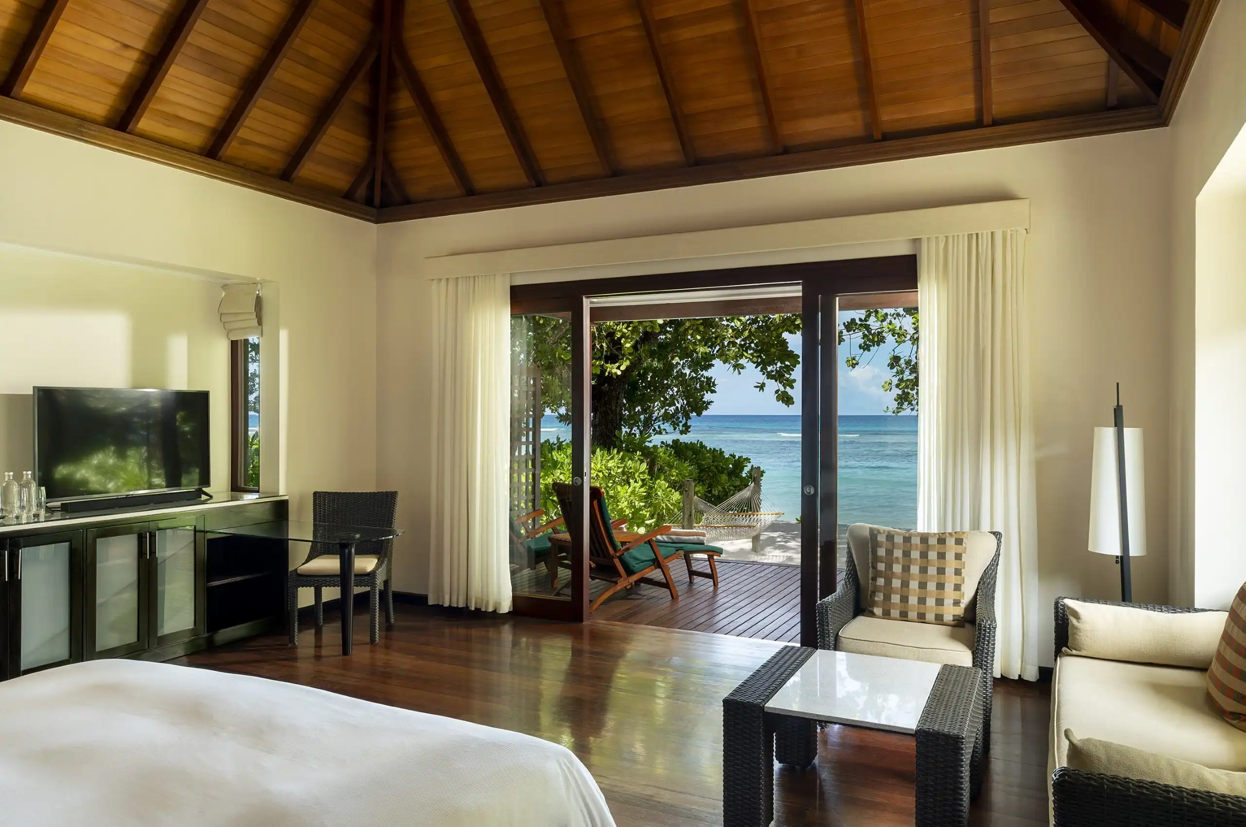niva labriz seychelles beach villa room with king bed and view of the ocean
