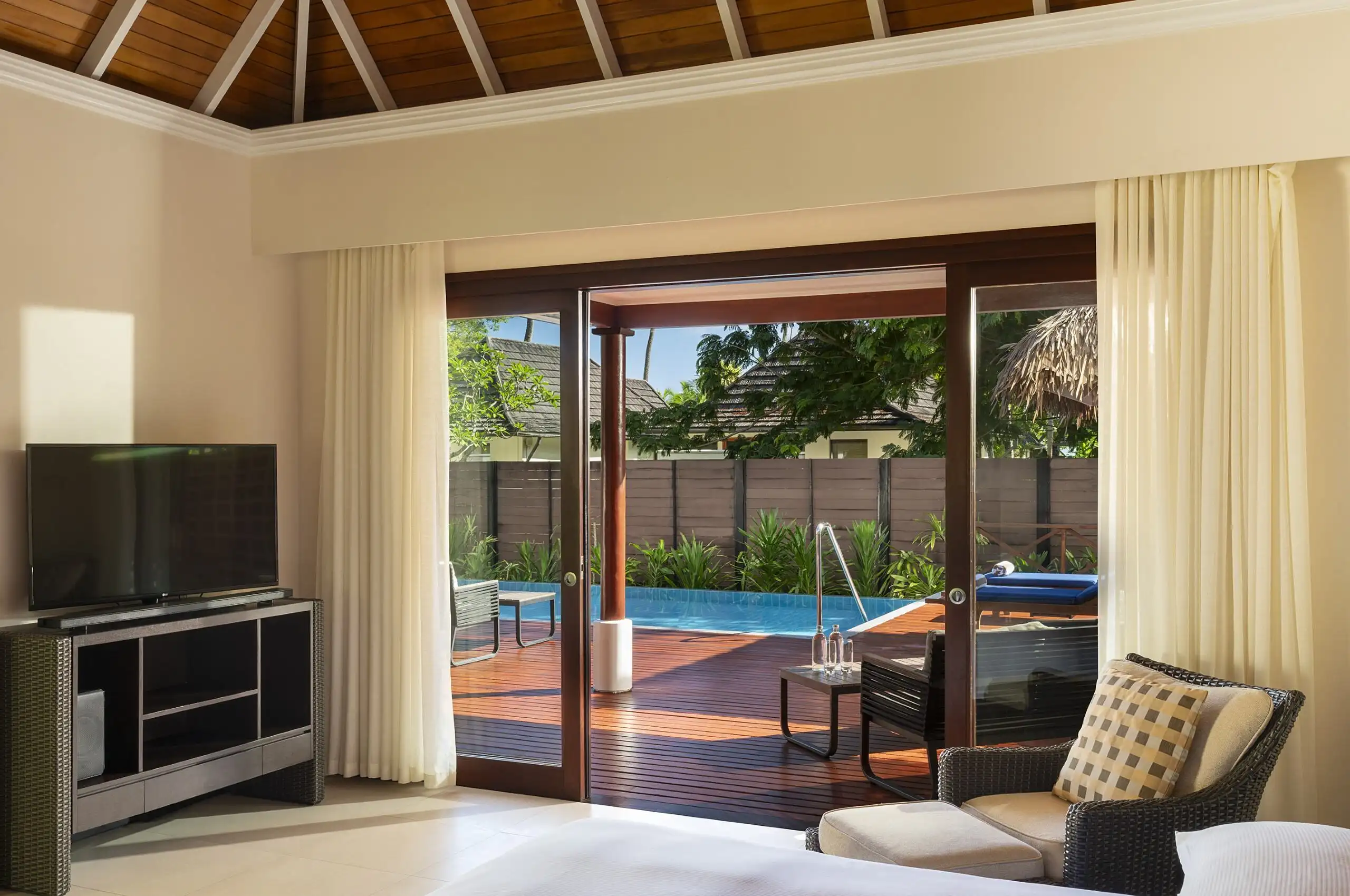 niva labriz seychelles beach villa with garden plunge pools bedroom with television and tropical decor
