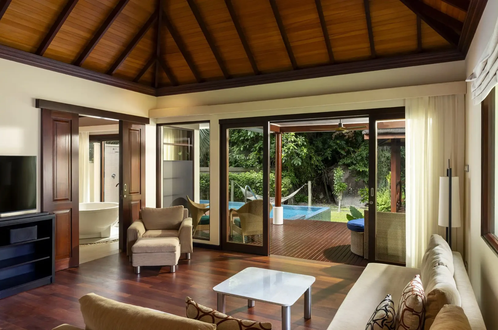niva labriz seychelles jungle sanctuary pool villa lounge area with comfortable seating and tropical surroundings