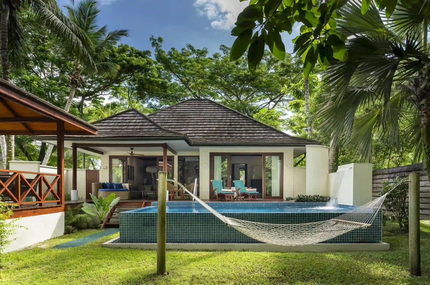 niva labriz seychelles jungle sanctuary pool villa pool area with hammock and tropical greenery