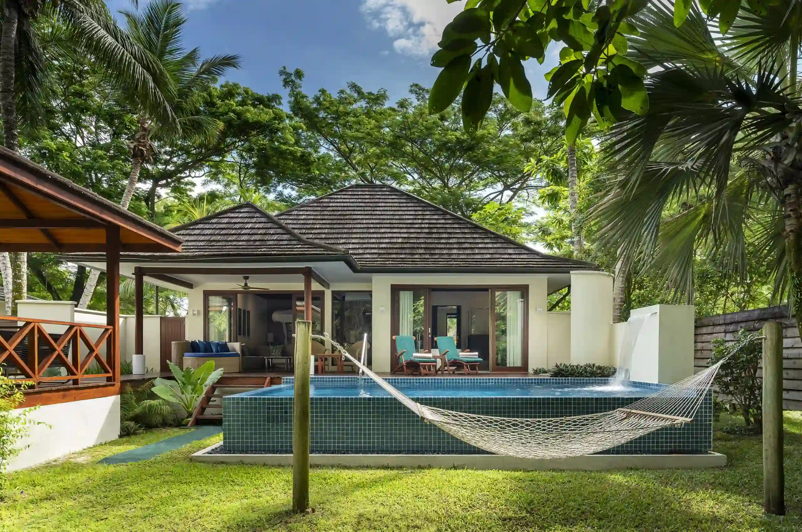 niva labriz seychelles jungle sanctuary pool villa pool area with hammock and tropical greenery