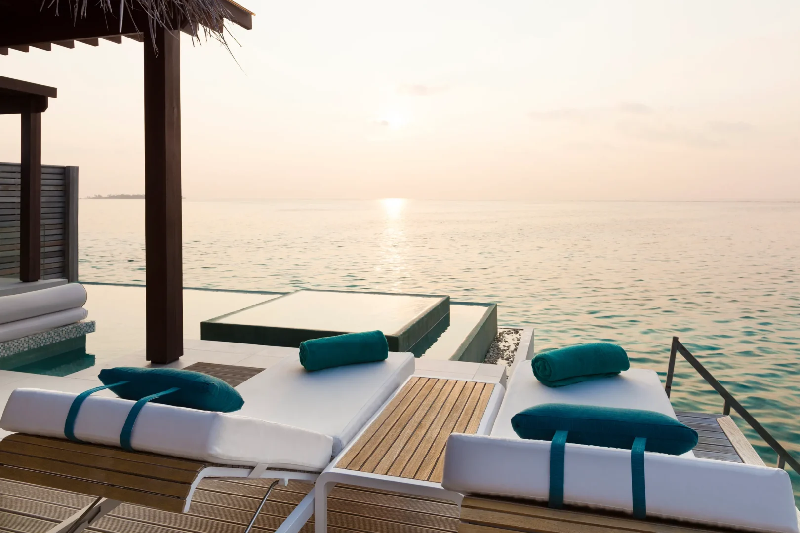 niyama private islands maldives deluxe over water pool villa sunrise view capturing warm morning light and serene oceanfront tranquility