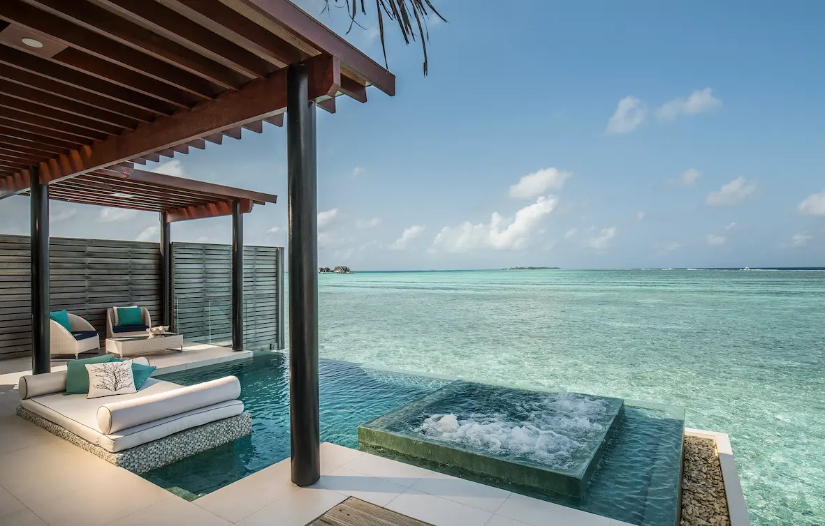 niyama private islands maldives deluxe over water pool villa terrace with serene oceanfront lounging and elevated island elegance