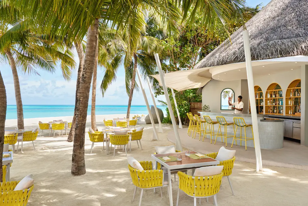 niyama private islands maldives dune with bartender showcasing relaxed beachfront bar ambiance and refined island style service