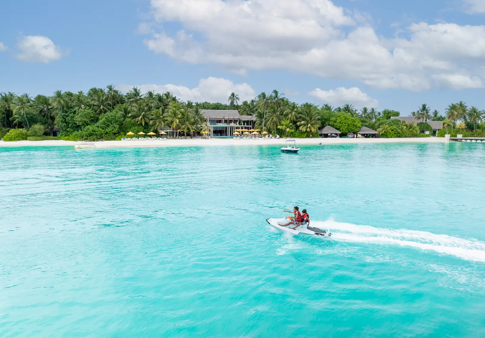 niyama private islands maldives jetski kids enjoying a fun ocean adventure with vibrant island energy and serene tropical surroundings