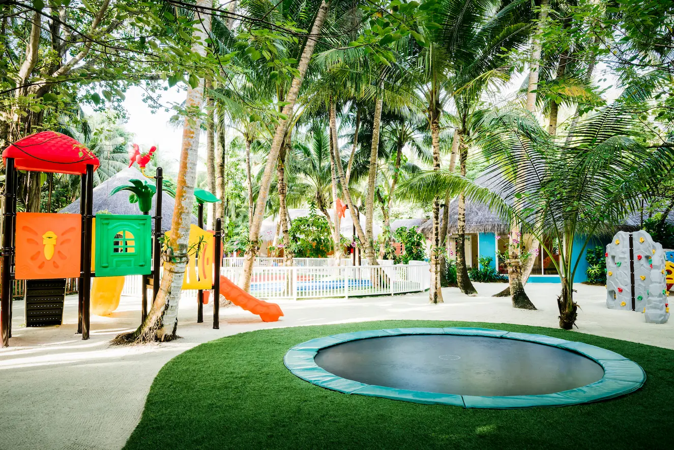 niyama private islands maldives kids enjoying on trampoline with playful island energy and relaxed beachfront surroundings
