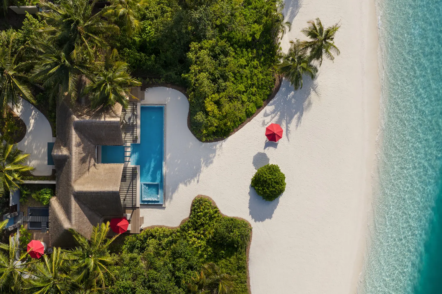 niyama private islands maldives one bedroom beach pool pavilion aerial view showcasing serene beachfront surroundings and elevated island luxury