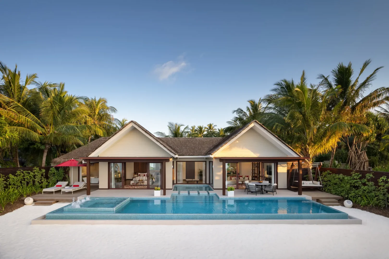 niyama private islands maldives one bedroom beach pool pavilion outdoor space featuring serene islandside lounging and refined contemporary elegance
