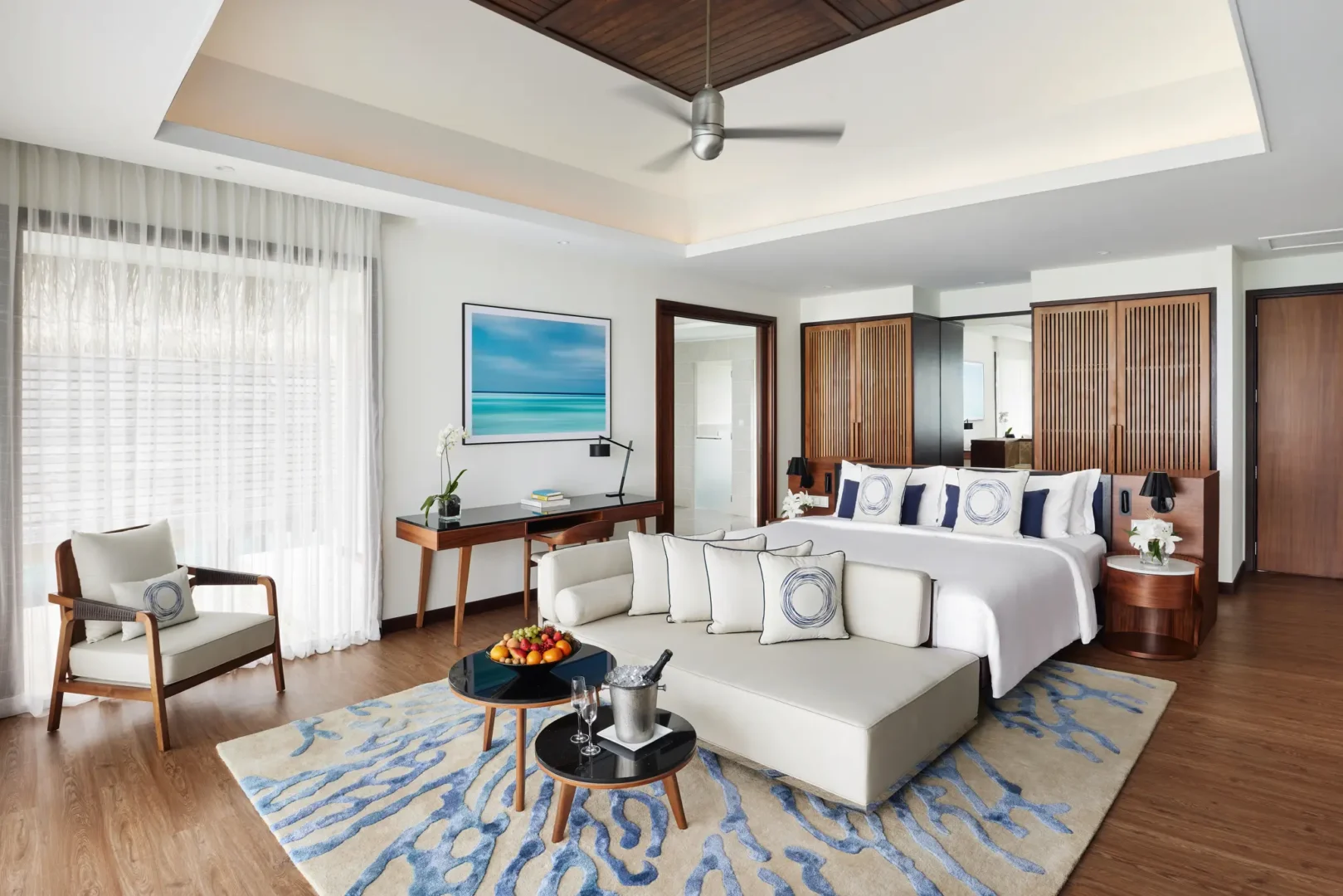 niyama private islands maldives over water pool villa bedroom interior featuring refined ocean inspired styling and tranquil contemporary island elegance