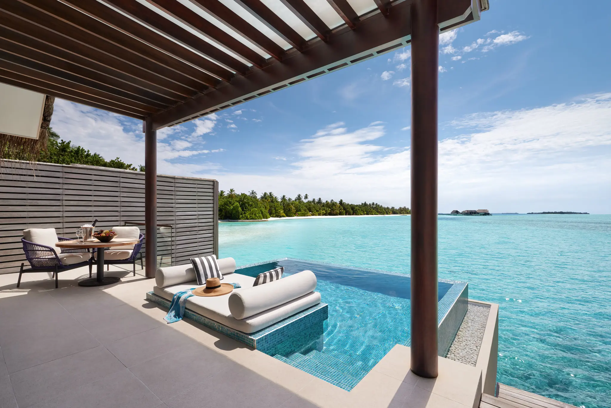 niyama private islands maldives over water pool villa deck overlooking indian ocean with serene panoramic views and elevated island luxury