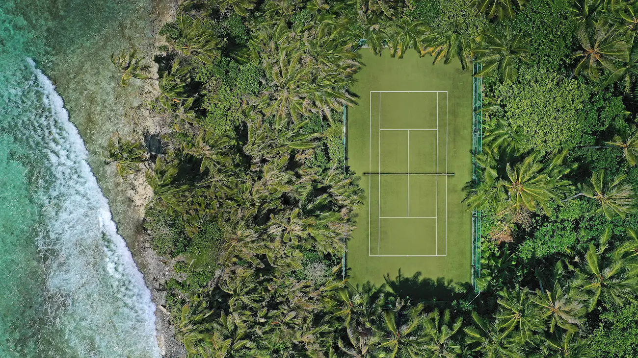 niyama private islands maldives recreation facility tennis court showcasing vibrant island sports facilities and serene tropical surroundings