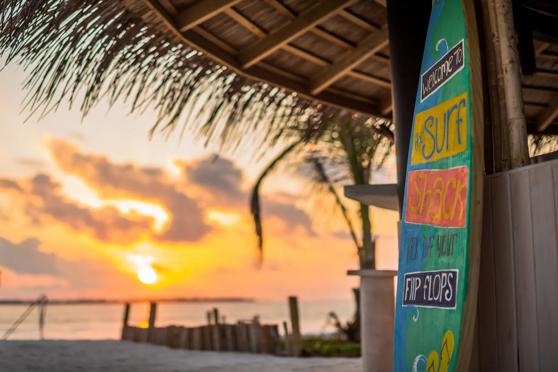 niyama private islands maldives surf shack sunset time capturing warm twilight ambiance and relaxed island beachfront vibes