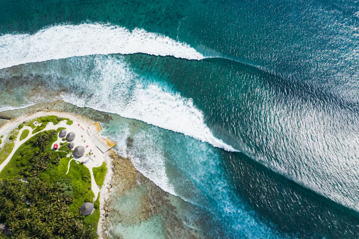 niyama private islands maldives vodi from above capturing elevated views of the iconic surf break and serene turquoise ocean scenery