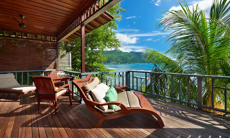 large balcony of northolme king premium oceanfront villa with lounge seating, tropical views, and panoramic oceanfront scenery