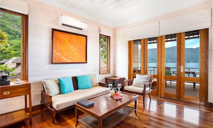 spacious lounge in northolme king sunset villa with modern furniture, large windows, and ocean view