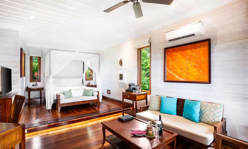 interior of northolme king sunset villa room with modern furnishings, king bed, tropical decor, and ocean view
