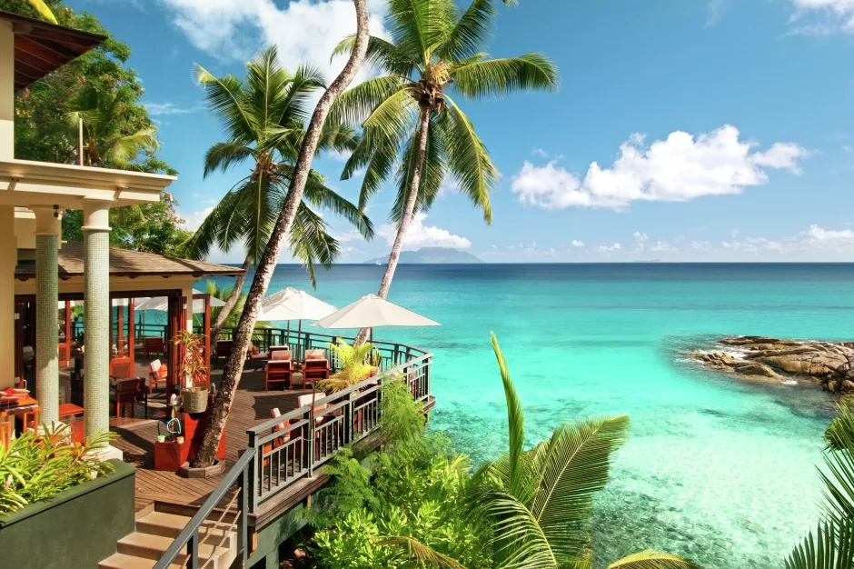 ocean view bar at northolme seychelles with tropical decor, seating area, and panoramic sea views