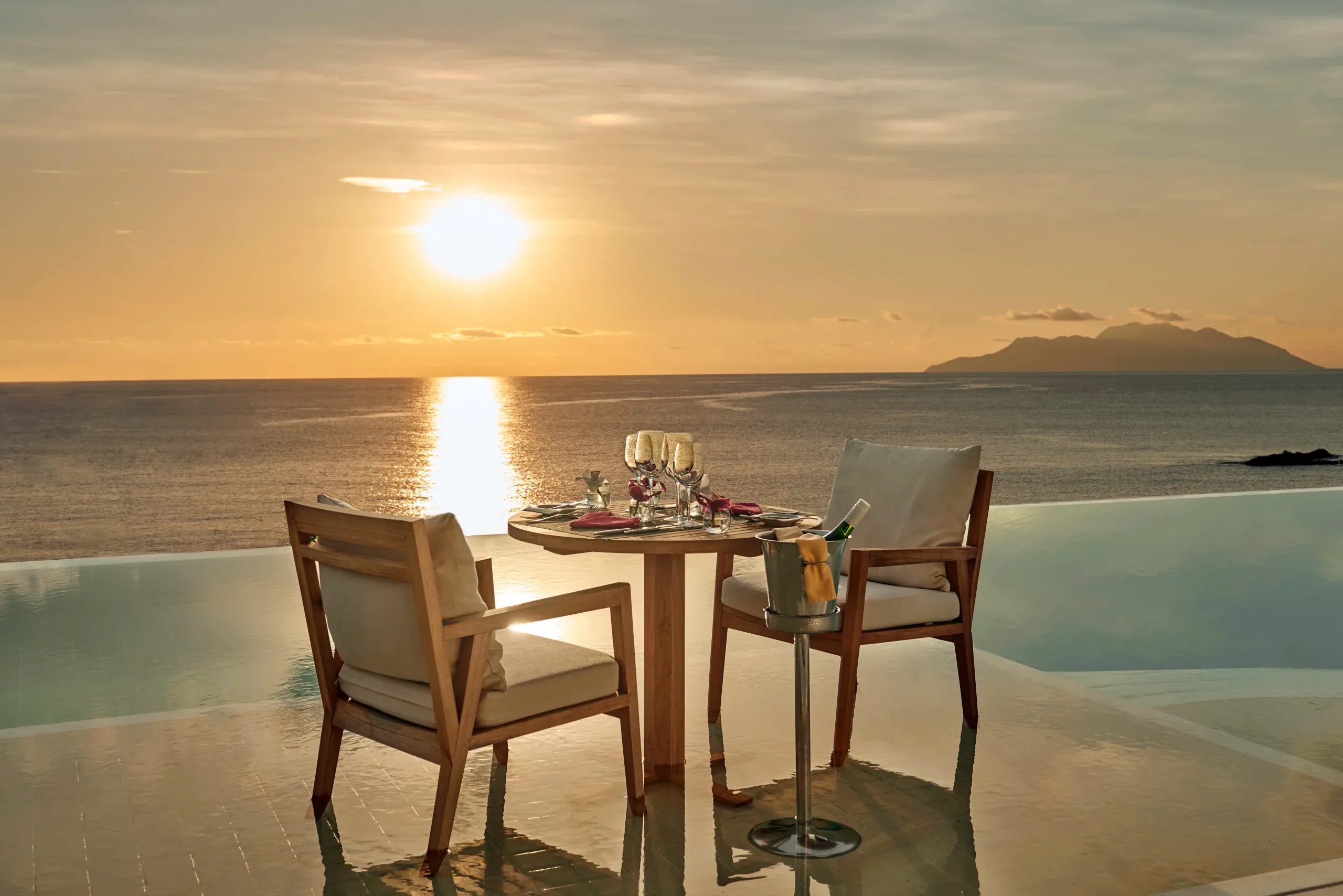 village dining area at northolme seychelles with outdoor seating, tropical decor, and ocean view