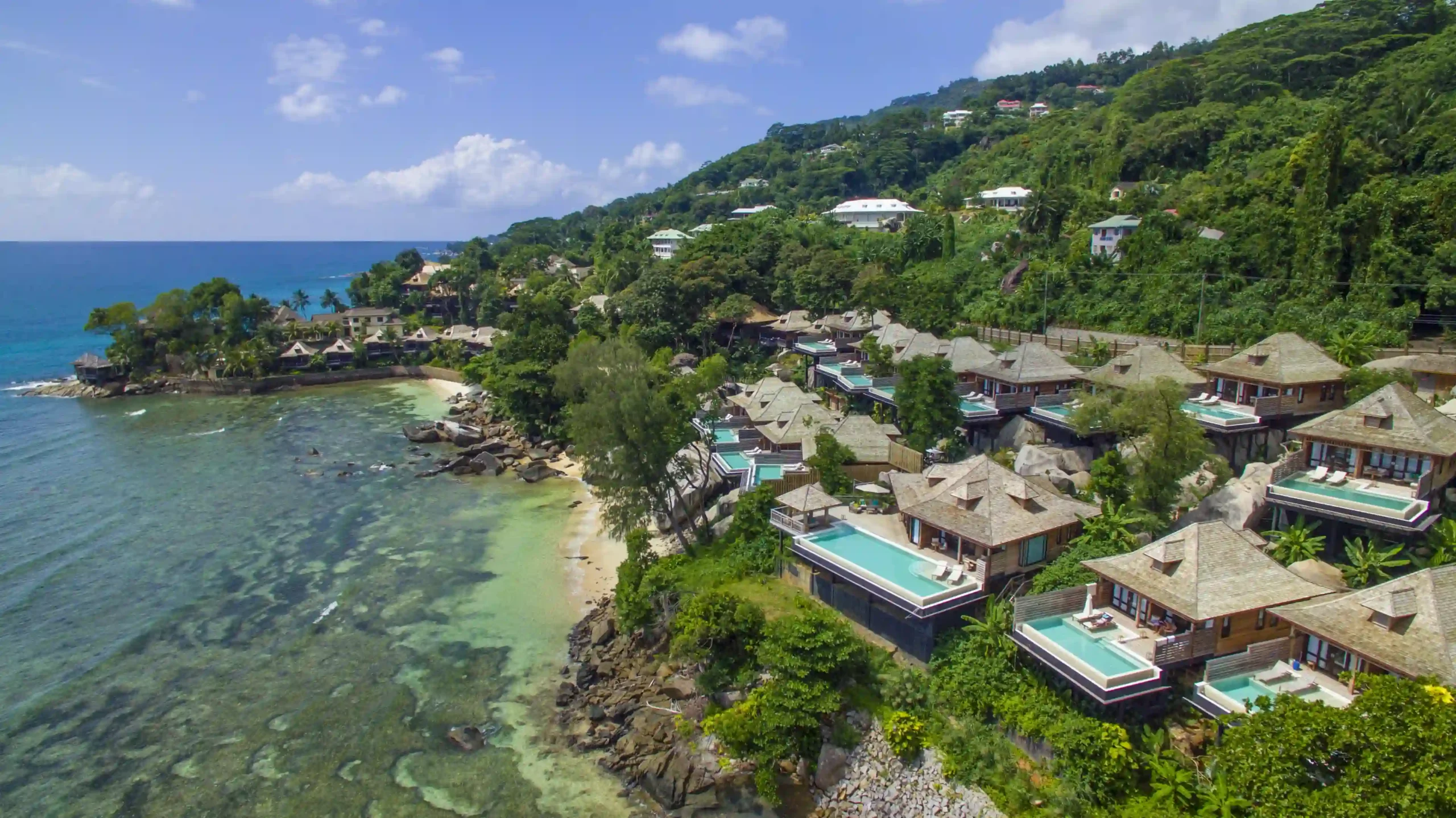 ide view of northolme seychelles villas nestled on a tropical hillside overlooking the ocean
