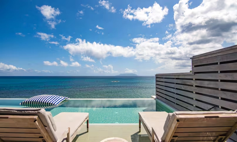 close-up of poolside loungers at northolme signature grand ocean pool villa with tropical surroundings and ocean view