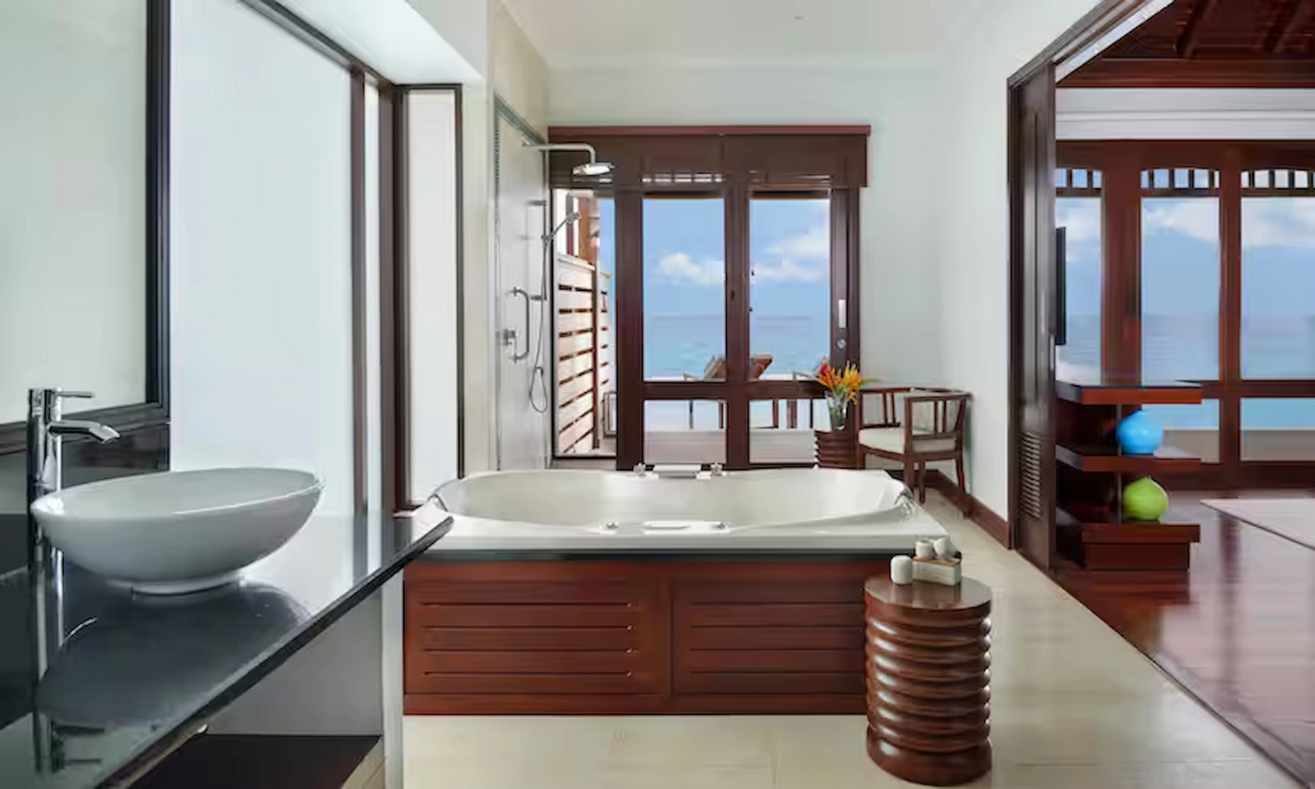 bathroom in northolme two bedroom oceanfront pool villa with modern fixtures, double sinks, and ocean view through large windows