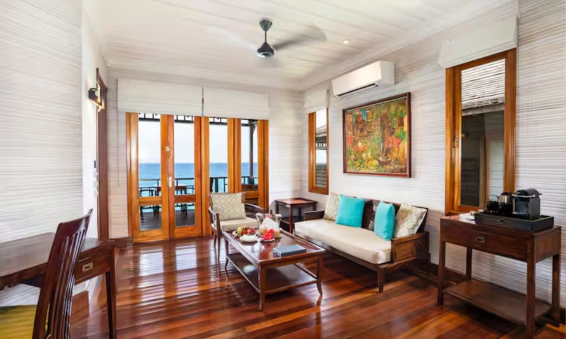 luxury room in northolme king ocean view villa with king bed, stylish tropical decor, large windows, and sweeping ocean views