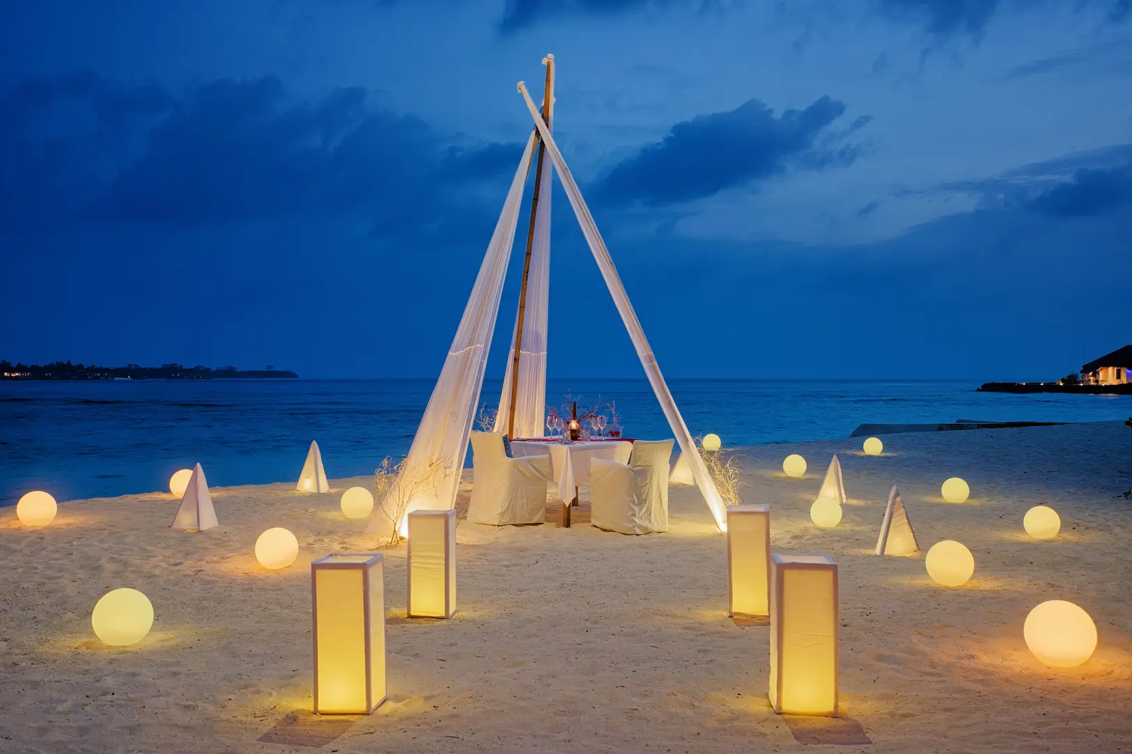 oblu nature helengeli activities and services beach dinner featuring elegant island dining setup warm ambient lighting and a calm romantic beachfront atmosphere