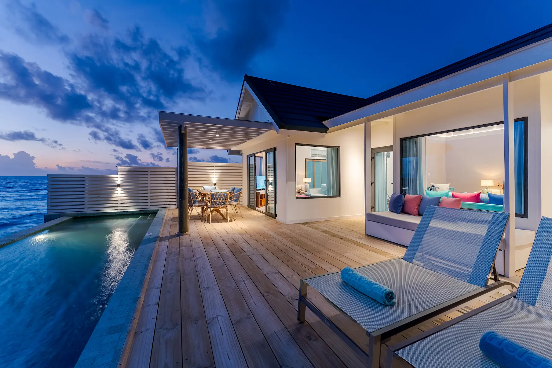 oblu nature helengeli water suite with pool sunset outdoor deck featuring warm golden light serene overwater views and a calm private island atmosphere