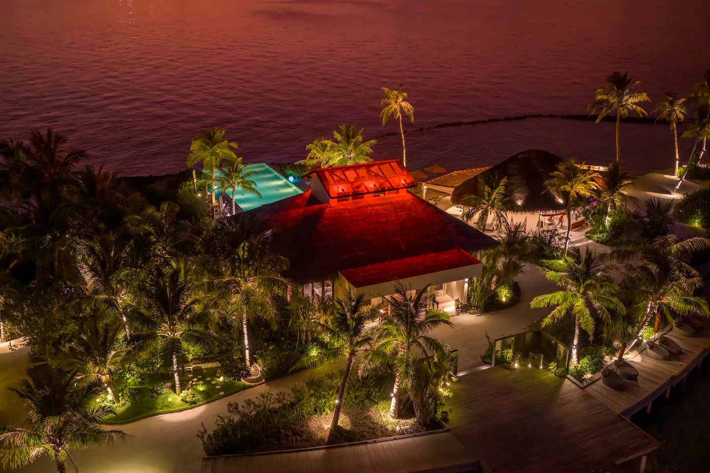 oblu select lobigili maldives full island aerial sunset swing bar dramatic sunset aerial of island swing bar with golden light turquoise lagoon and serene tropical ambience