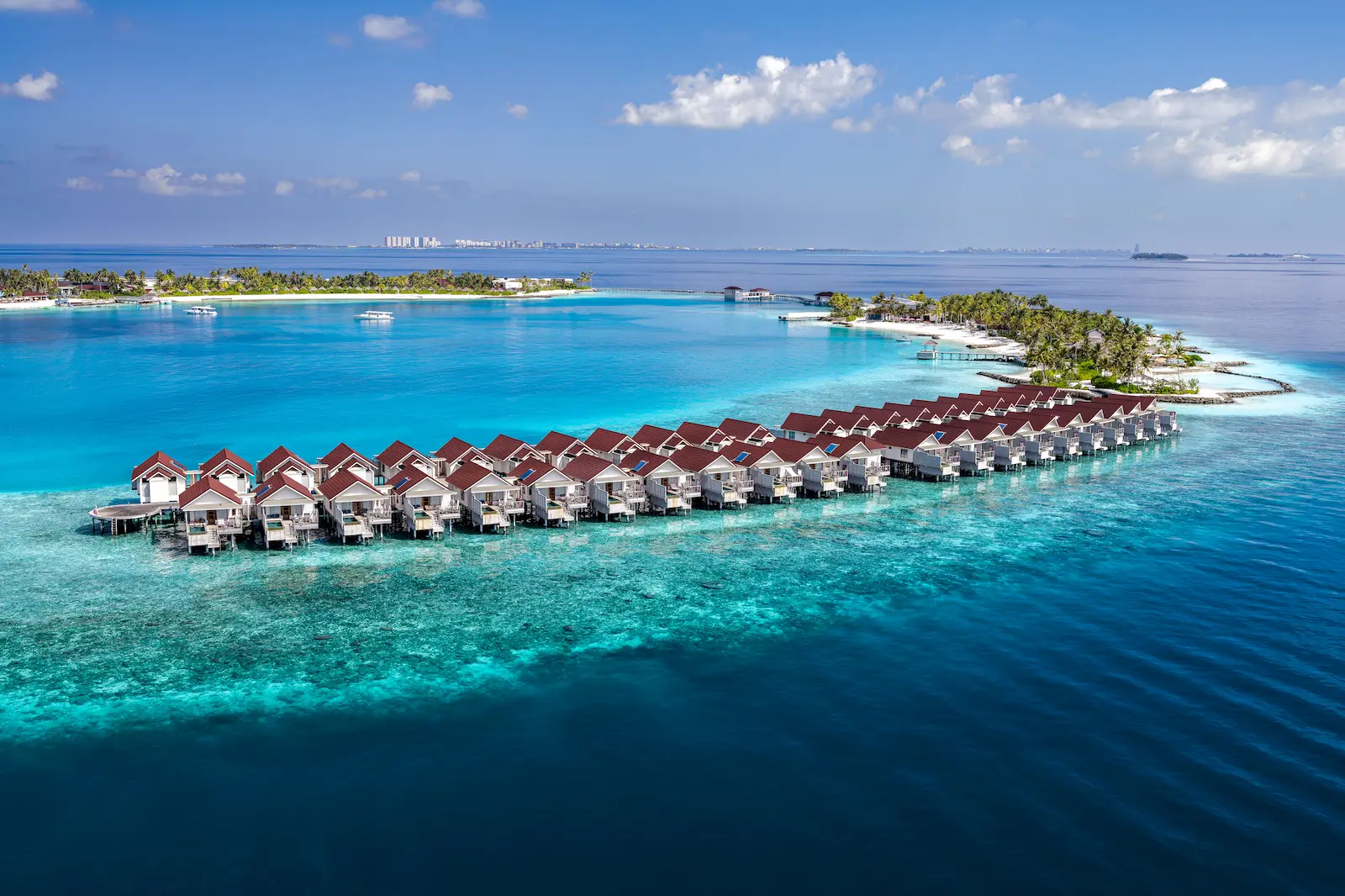 oblu select lobigili maldives full island aerial expansive aerial view of tropical island surrounded by turquoise waters showcasing serene luxury and lush greenery