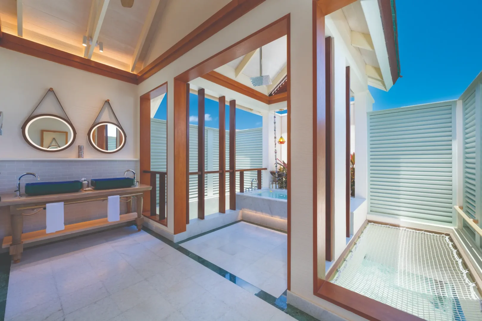oblu select lobigili maldives nest water villa bathroom elegant overwater bathroom with natural textures soft lighting and serene lagoon backdrop