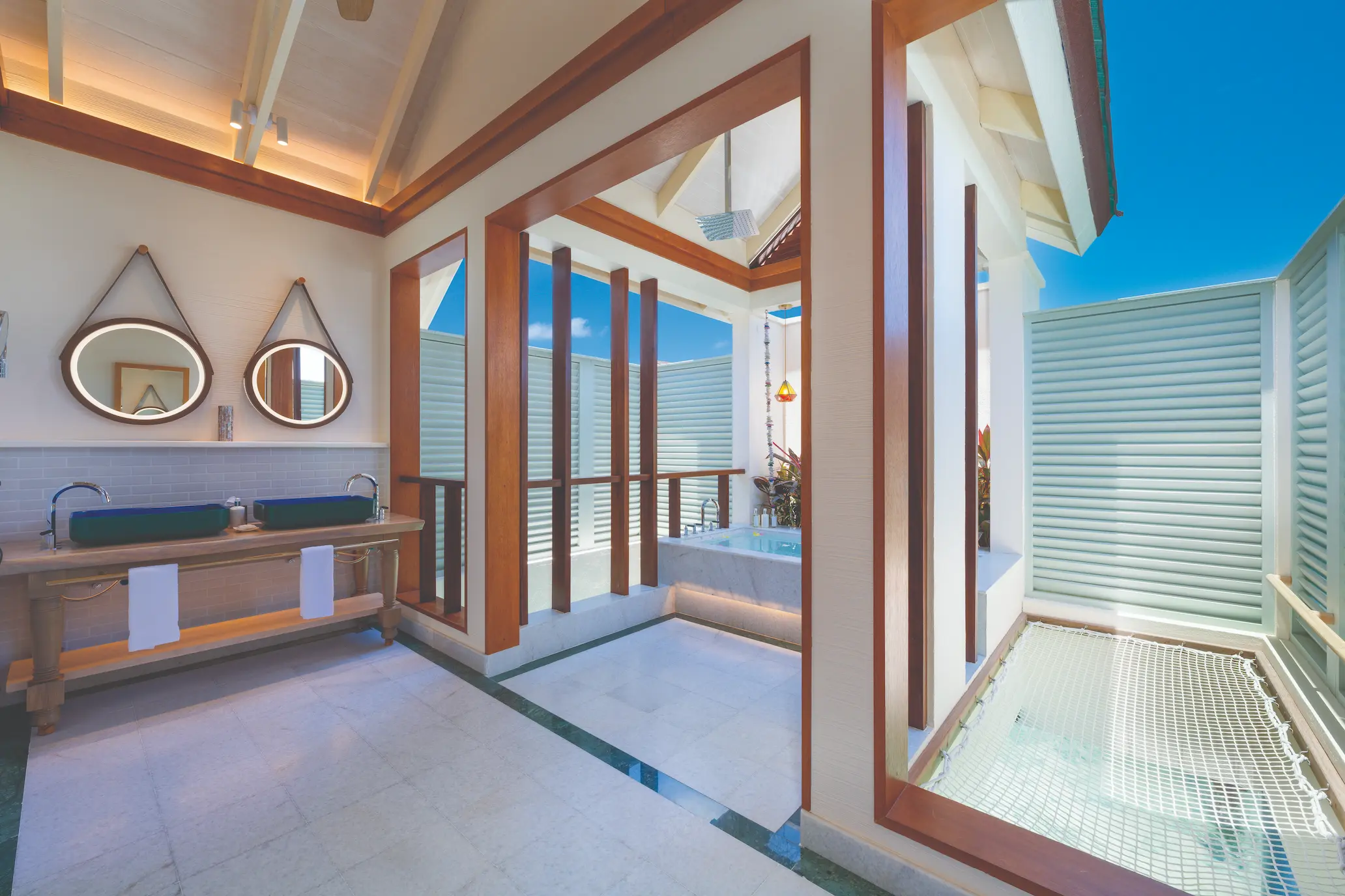 oblu select lobigili maldives nest water villa bathroom elegant overwater bathroom with natural textures soft lighting and serene lagoon backdrop