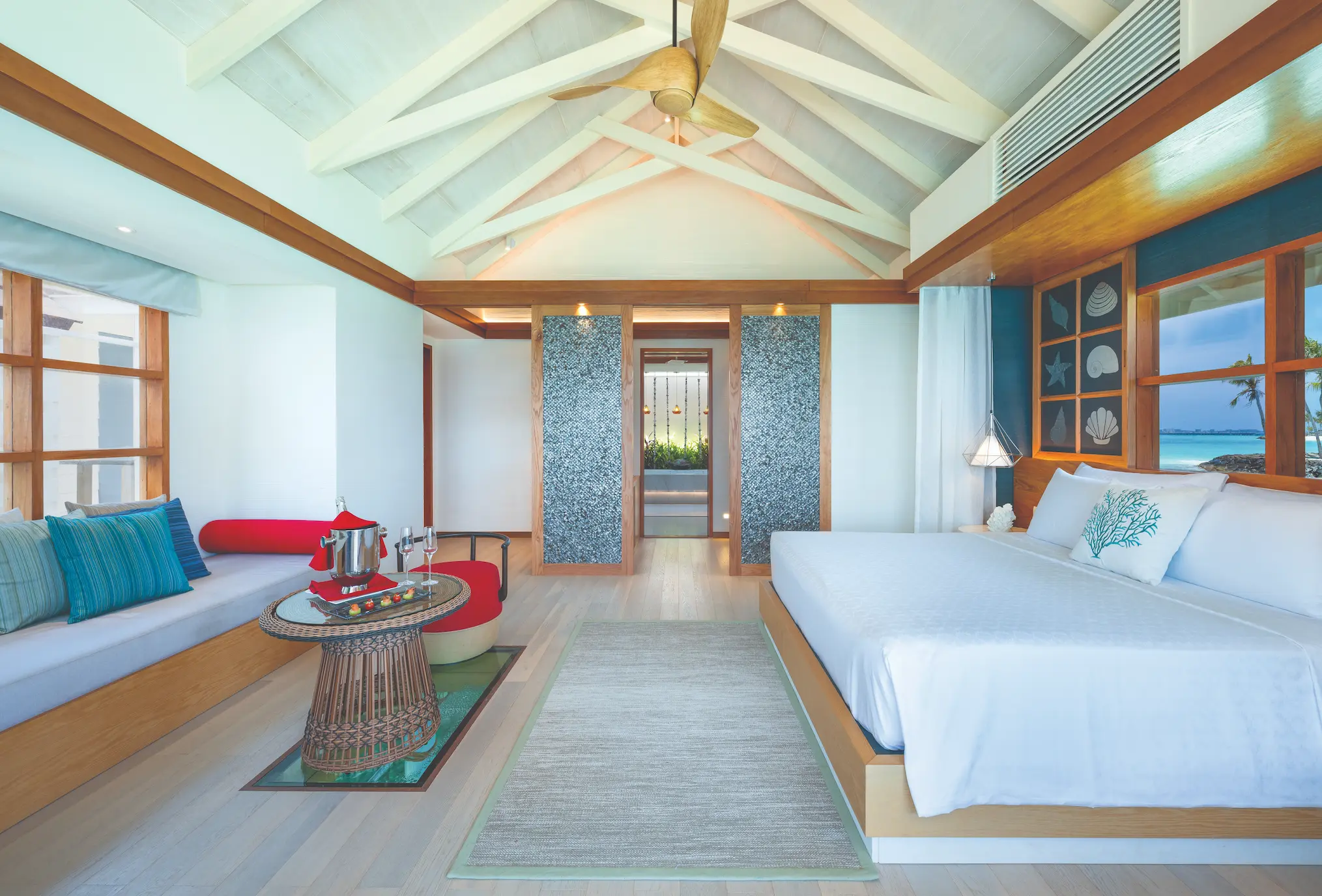 oblu select lobigili maldives nest water villa bedroom serene overwater bedroom with panoramic lagoon views warm wood textures and refined island ambience