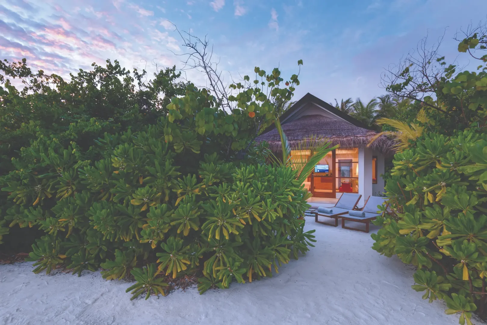 oblu select sangeli maldives beach villa exterior tranquil beachfront villa exterior with tropical greenery warm wood details and serene island ambience
