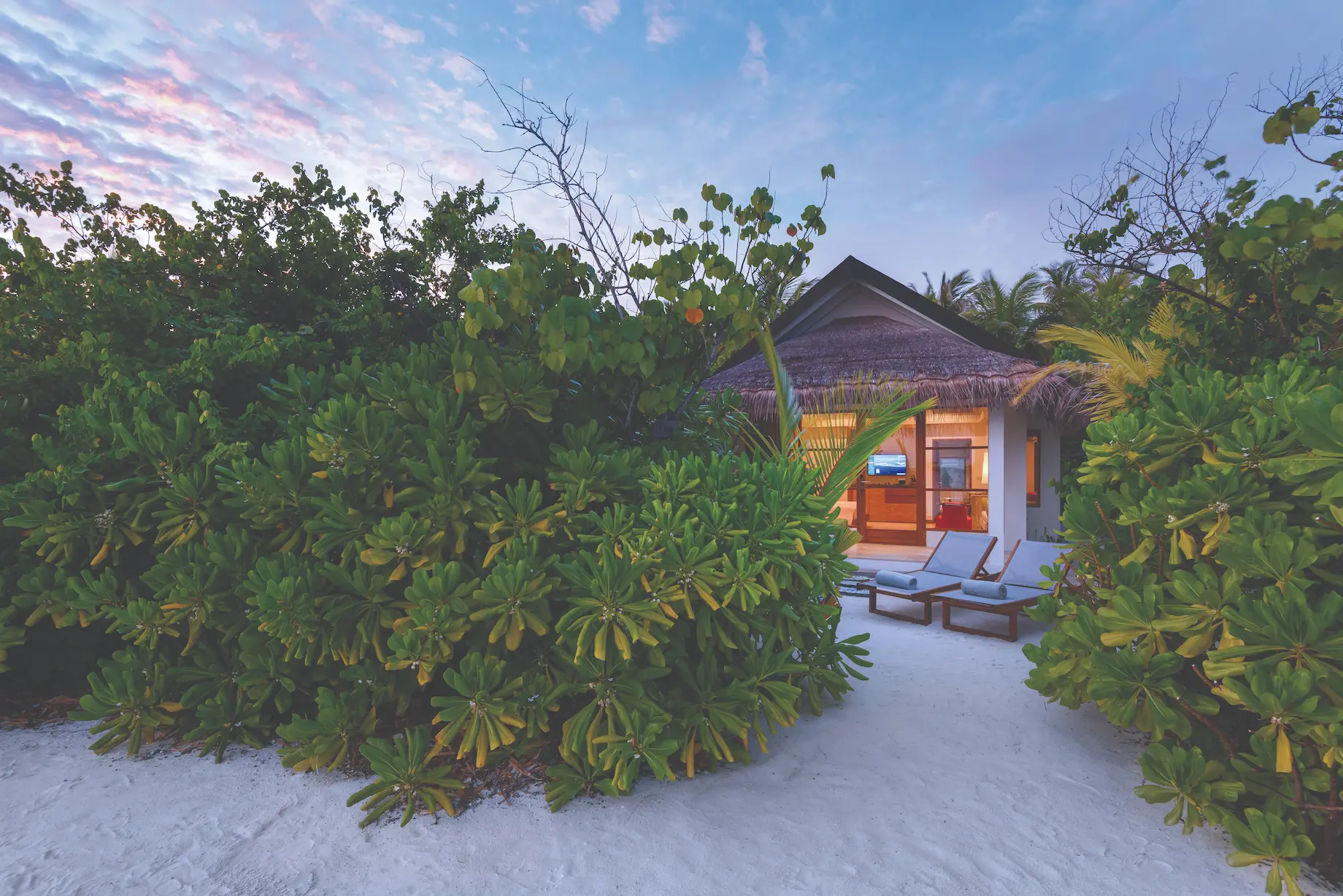 oblu select sangeli maldives beach villa exterior tranquil beachfront villa exterior with tropical greenery warm wood details and serene island ambience