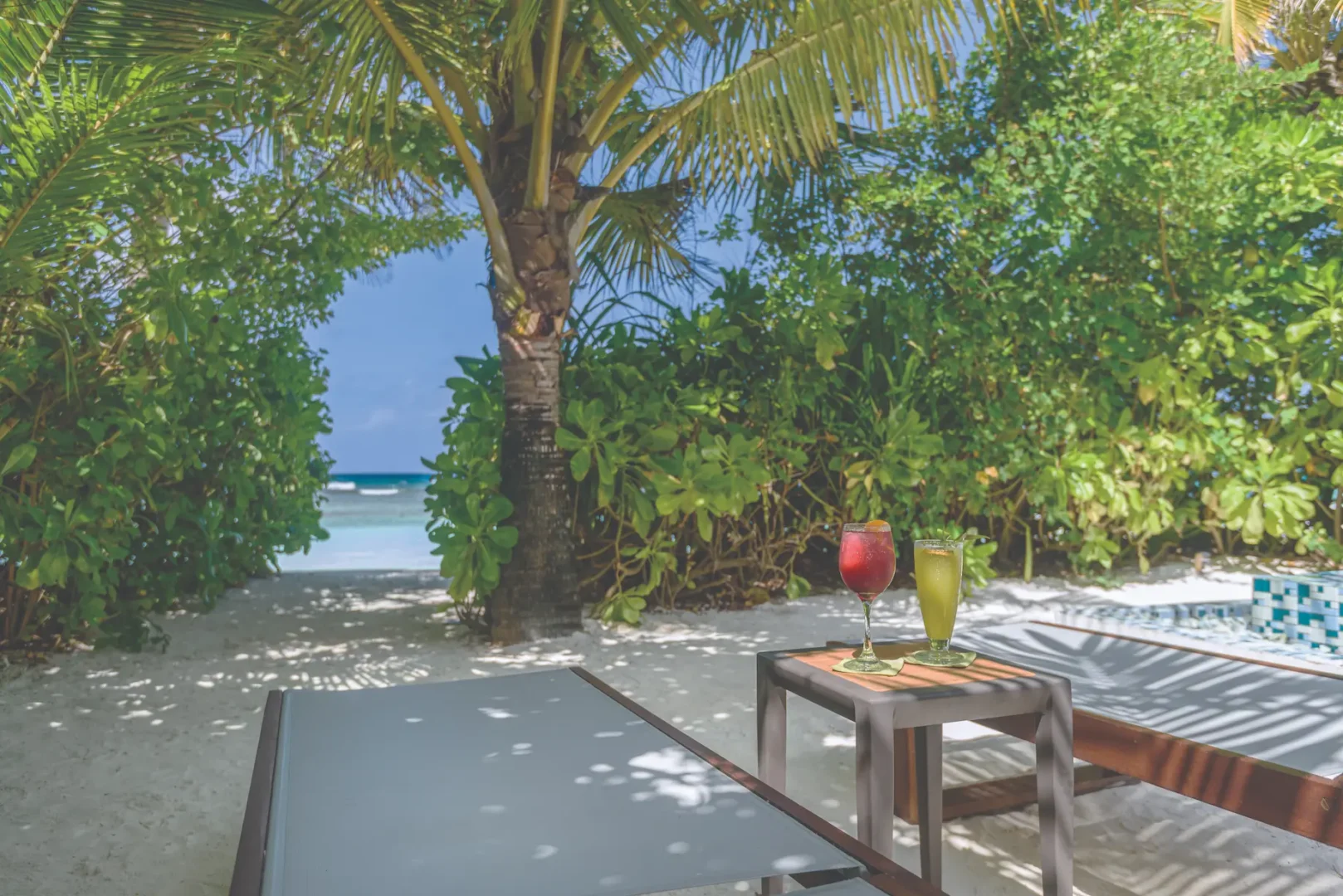 oblu select sangeli maldives beach villa with pool sunbed relaxing poolside sunbed setting with tropical greenery warm island light and serene beach ambience