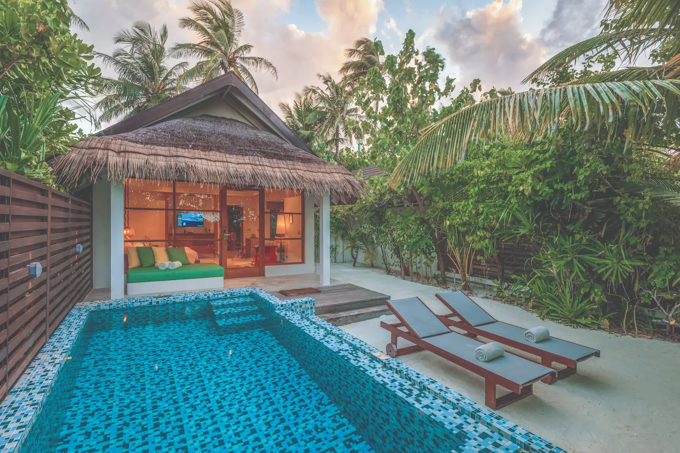 oblu select sangeli maldives beach villa with pool sunset peaceful sunset view over private pool with warm golden light tropical greenery and serene island ambience
