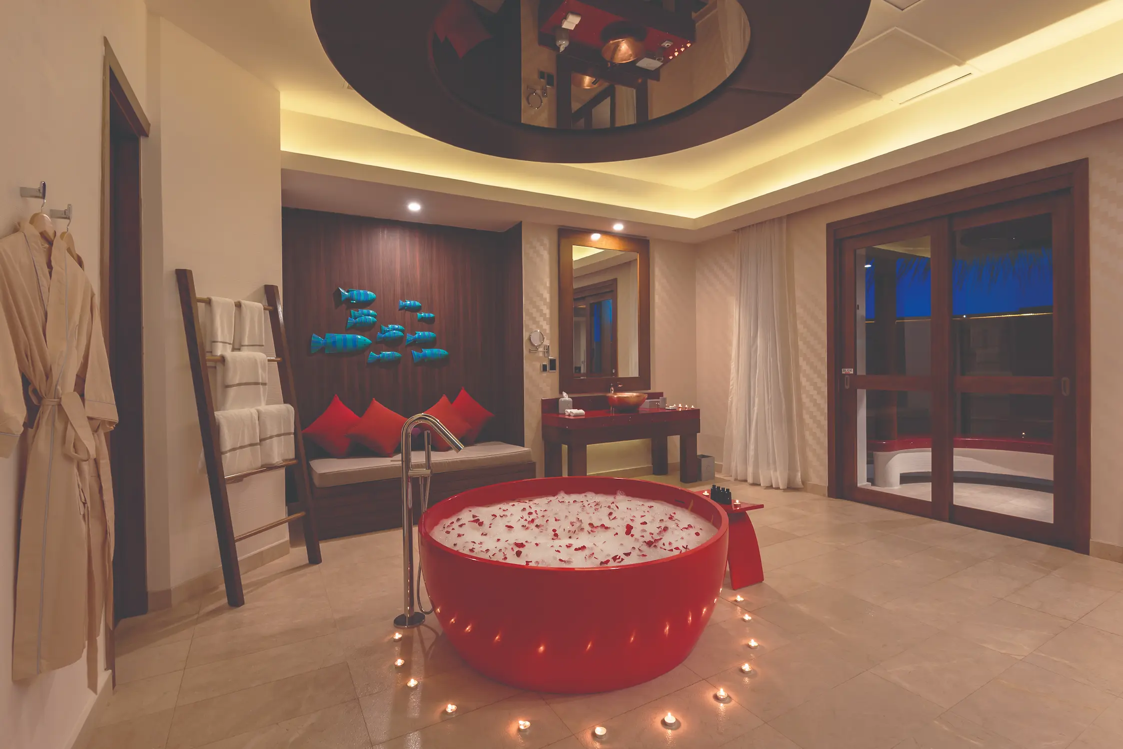oblu select sangeli maldives honeymoon ocean suite bathroom evening elegant overwater bathroom glowing with soft evening light serene lagoon reflections and refined tropical ambience