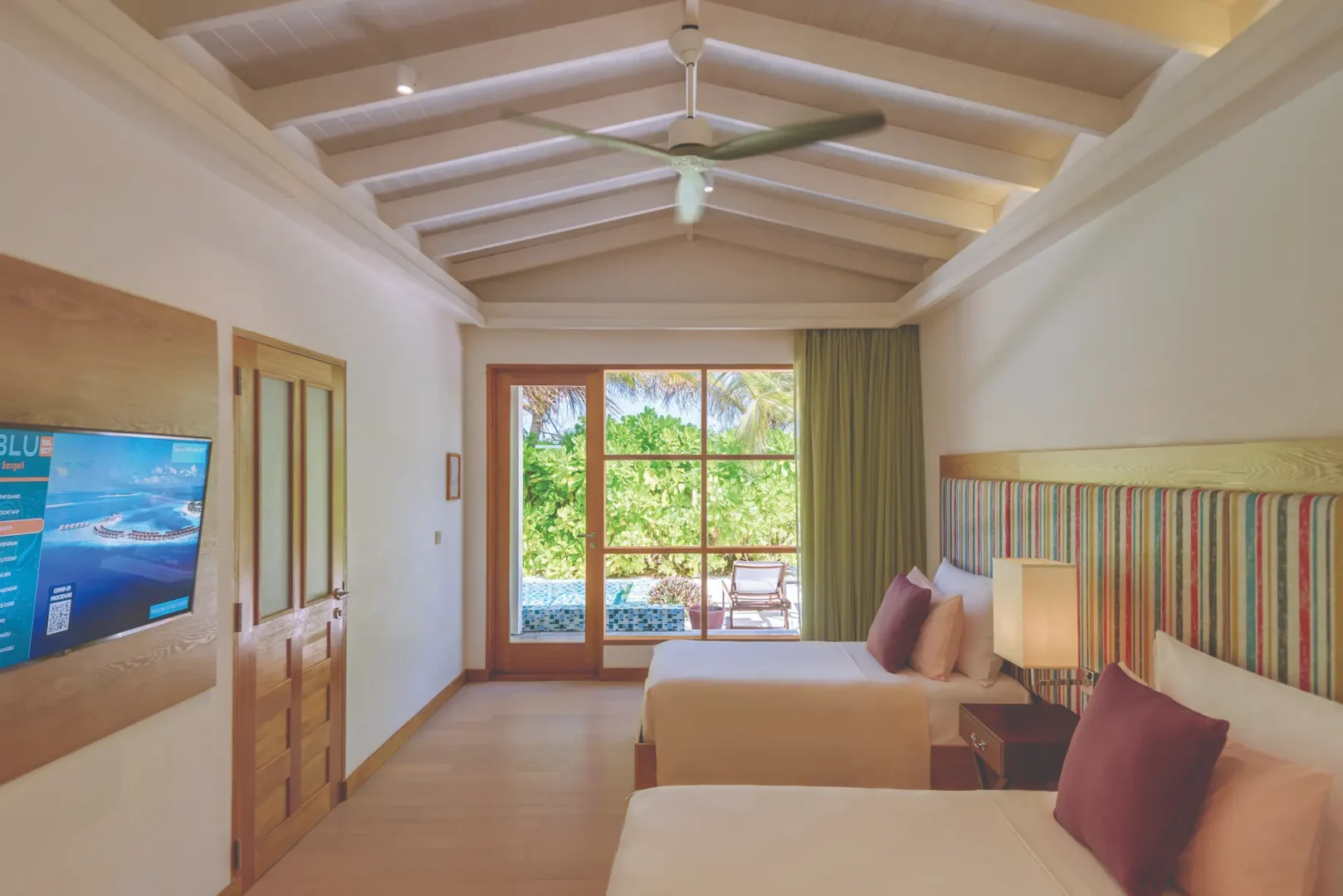 oblu select sangeli maldives two bedroom family villa with pool kids room view bright family bedroom with playful details warm natural light and serene tropical ambience