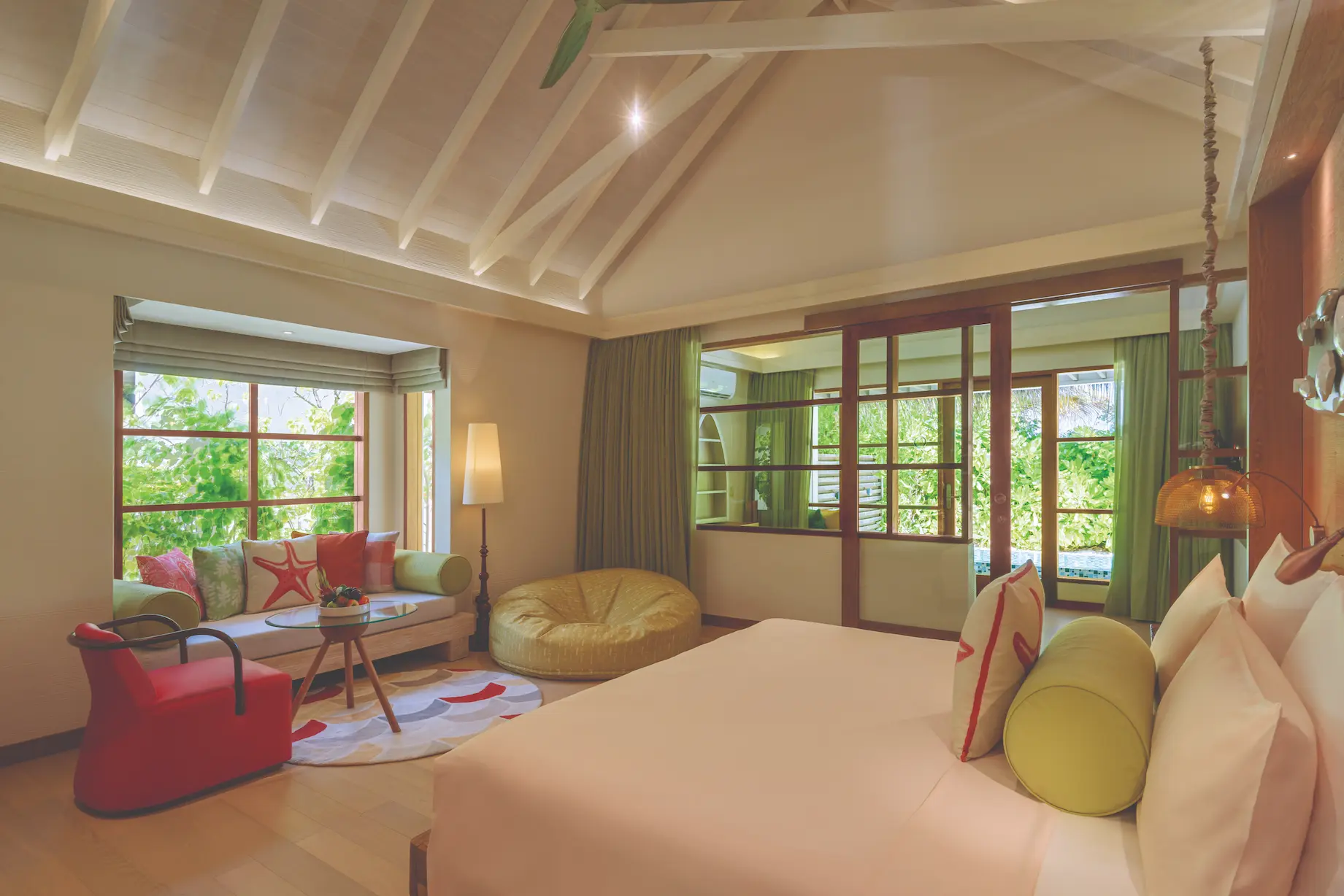 oblu select sangeli maldives two bedroom family villa with pool master bedroom view elegant master bedroom opening to tropical garden views with warm natural light and serene island ambience