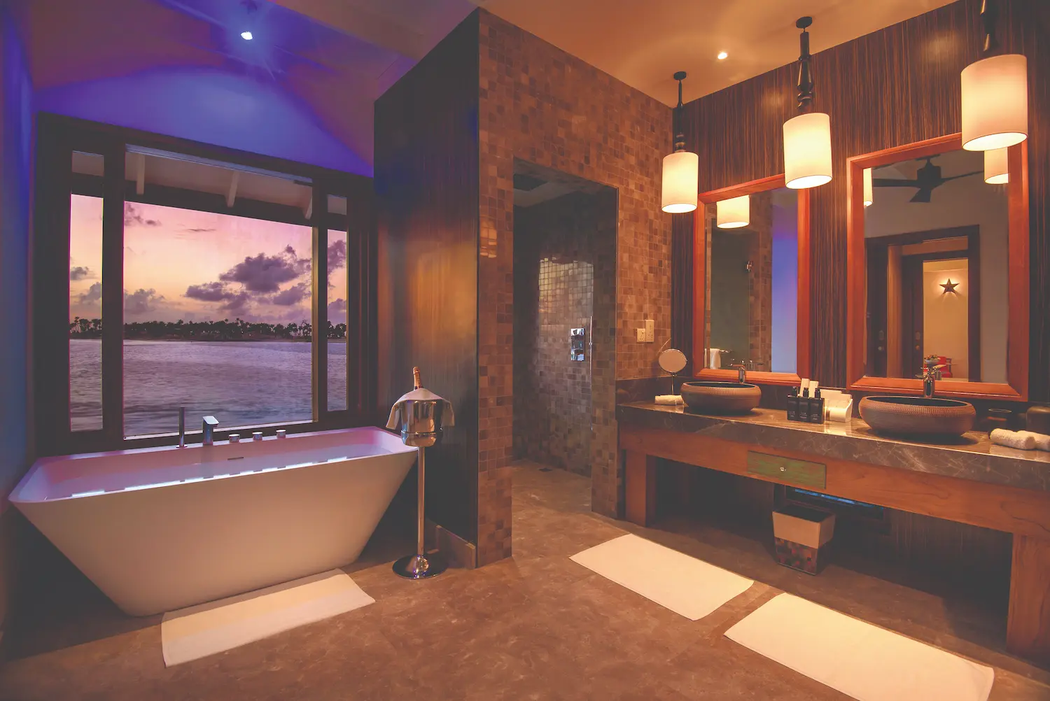 oblu select sangeli maldives water villa bathroom sunset elegant overwater bathroom glowing with warm sunset light serene lagoon views and refined tropical ambience