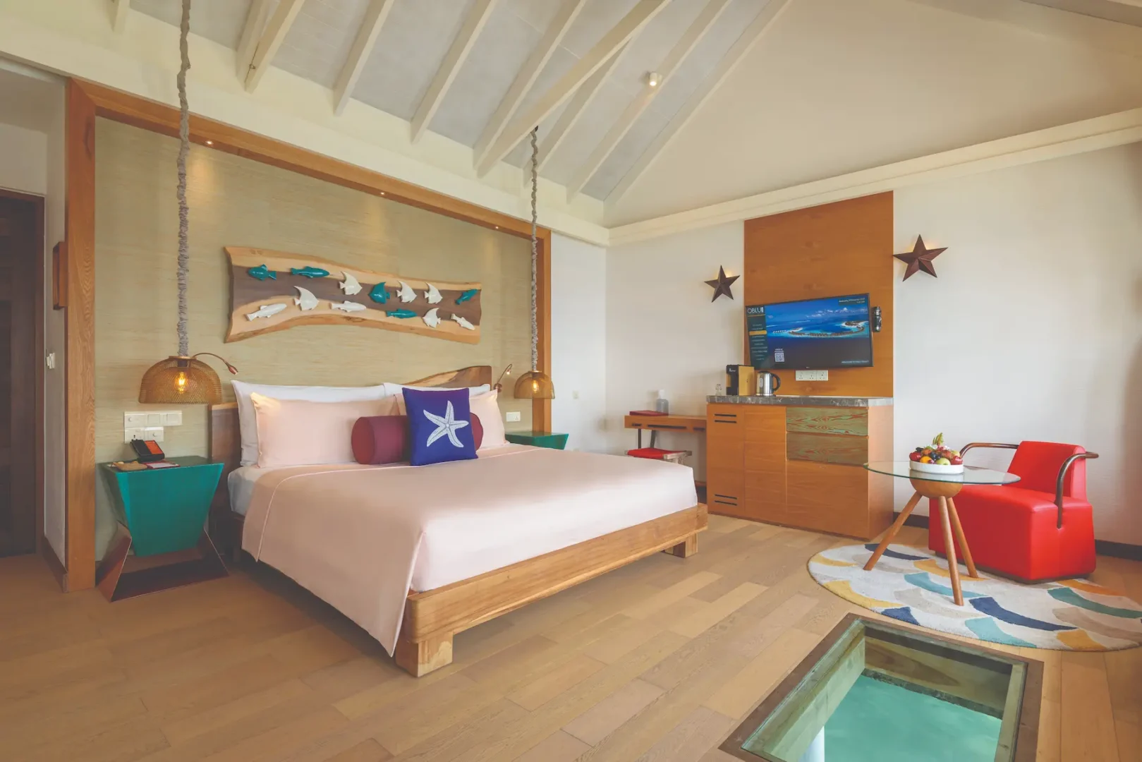 oblu select sangeli maldives water villa bedroom interior elegant overwater bedroom with warm wood accents soft natural light and serene lagoon ambience