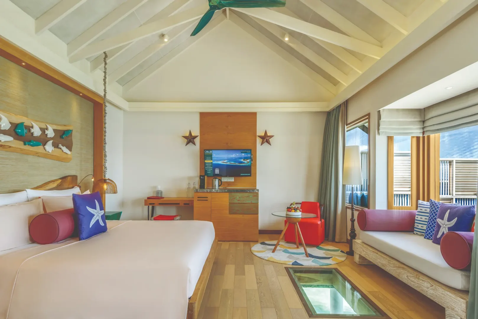 oblu select sangeli maldives water villa bedroom interior two elegant overwater bedroom with warm natural tones soft ambient light and serene lagoon backdrop