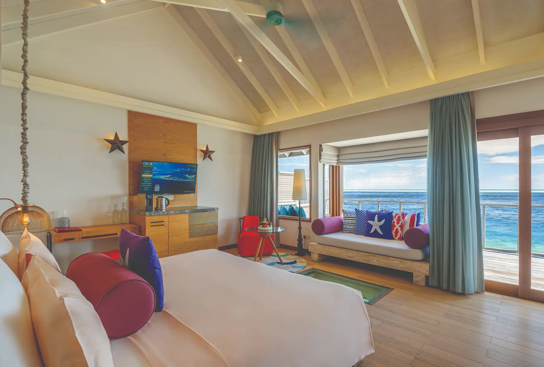 oblu select sangeli maldives water villa bedroom view serene overwater bedroom opening to lagoon views with warm natural tones and refined tropical ambience